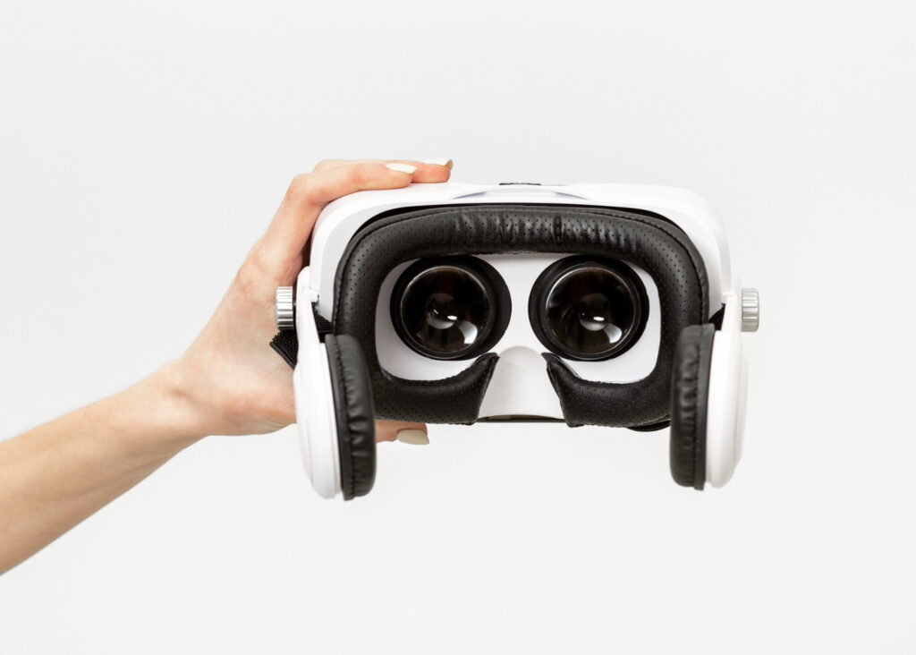 hand holding white VR showing lenses