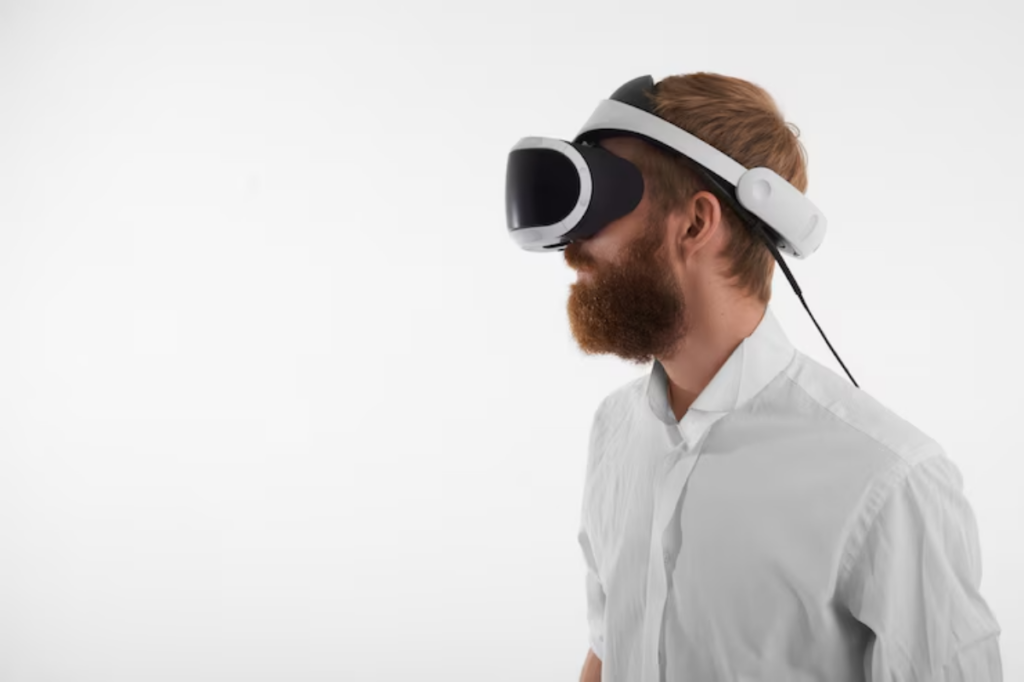A person wearing a virtual reality headset and a white shirt, engaged in immersive technology against a plain white background.