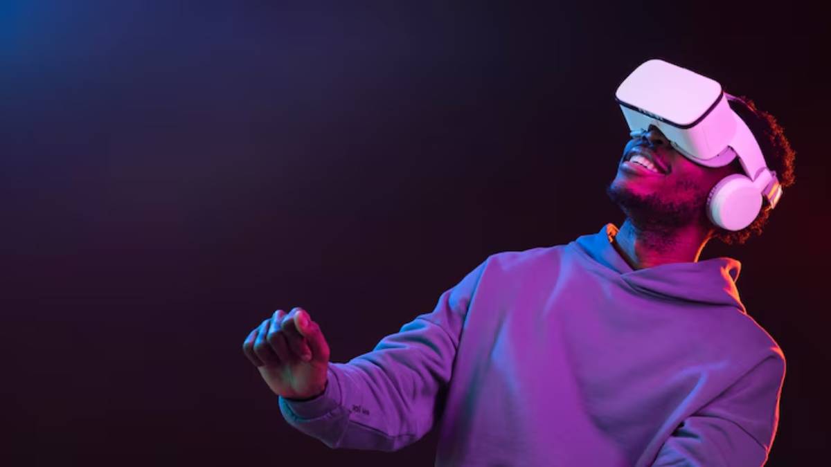 A person wearing a virtual reality headset and headphones, gesturing excitedly against a colorful, gradient background.