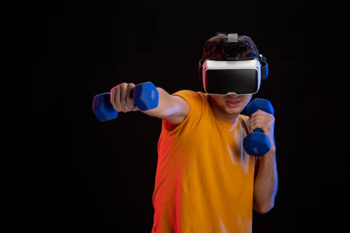 A person wearing a virtual reality headset exercises with blue dumbbells against a dark background, showcasing active engagement in fitness.