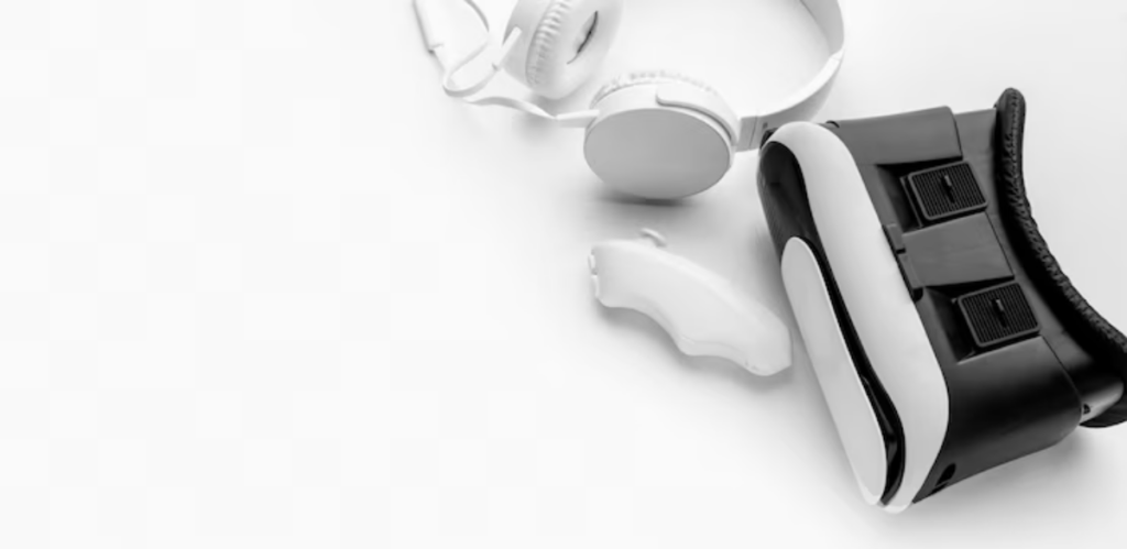 A black and white collection of virtual reality gear, featuring a headset, white headphones, and a gaming controller on a light background.