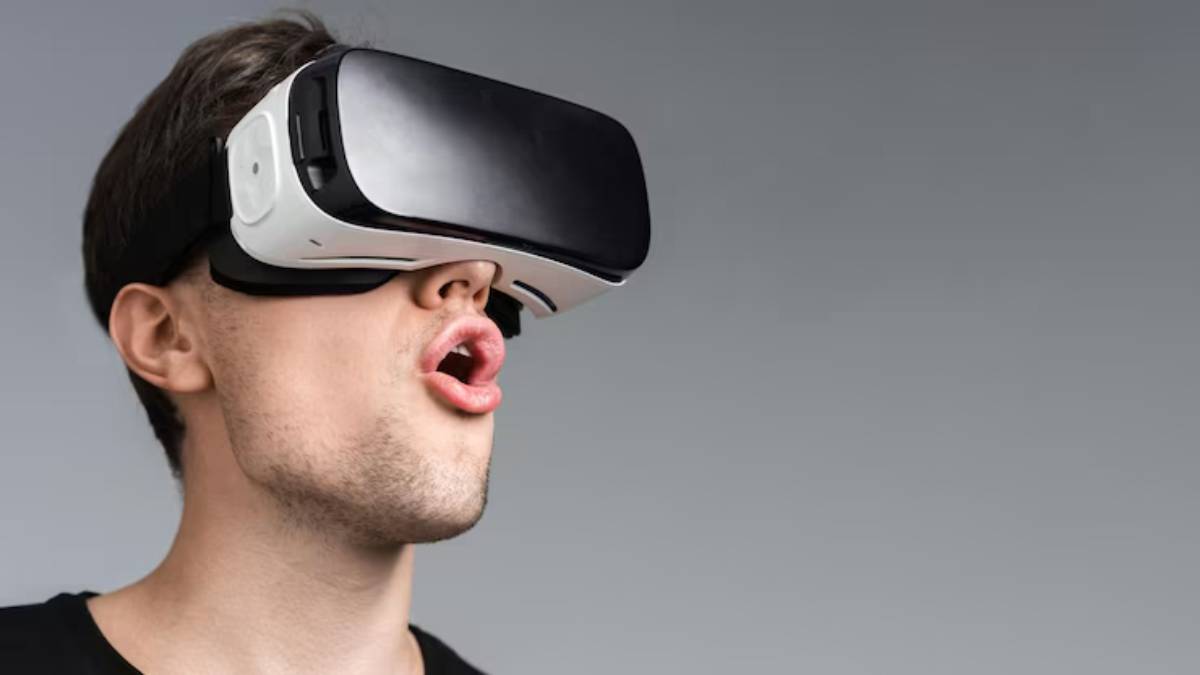 A person wearing a virtual reality headset, focused on an immersive experience against a minimalist gray background.
