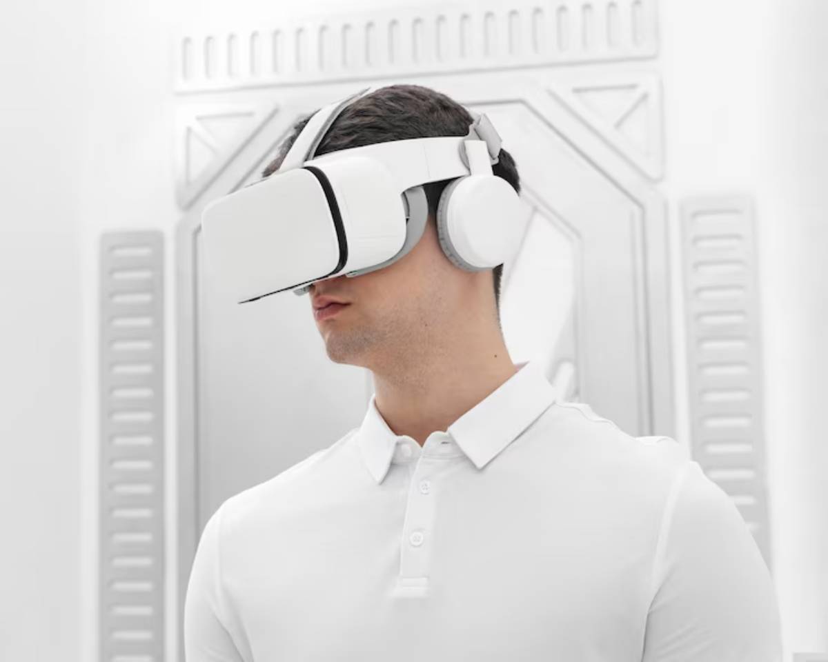 A person wearing a white VR headset and headphones stands against a sleek, futuristic white backdrop.