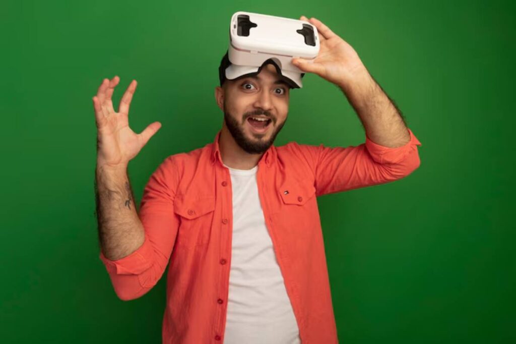 A person wearing a VR headset, raising hands in excitement, against a bright green background, embodying a virtual reality experience.