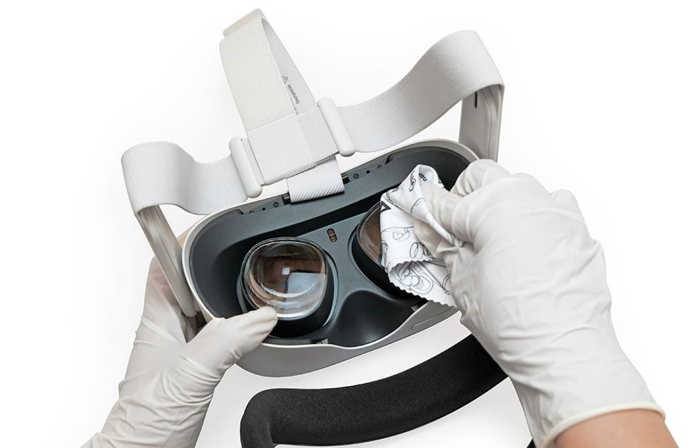 hands cleaning lenses of VR with a cloth
