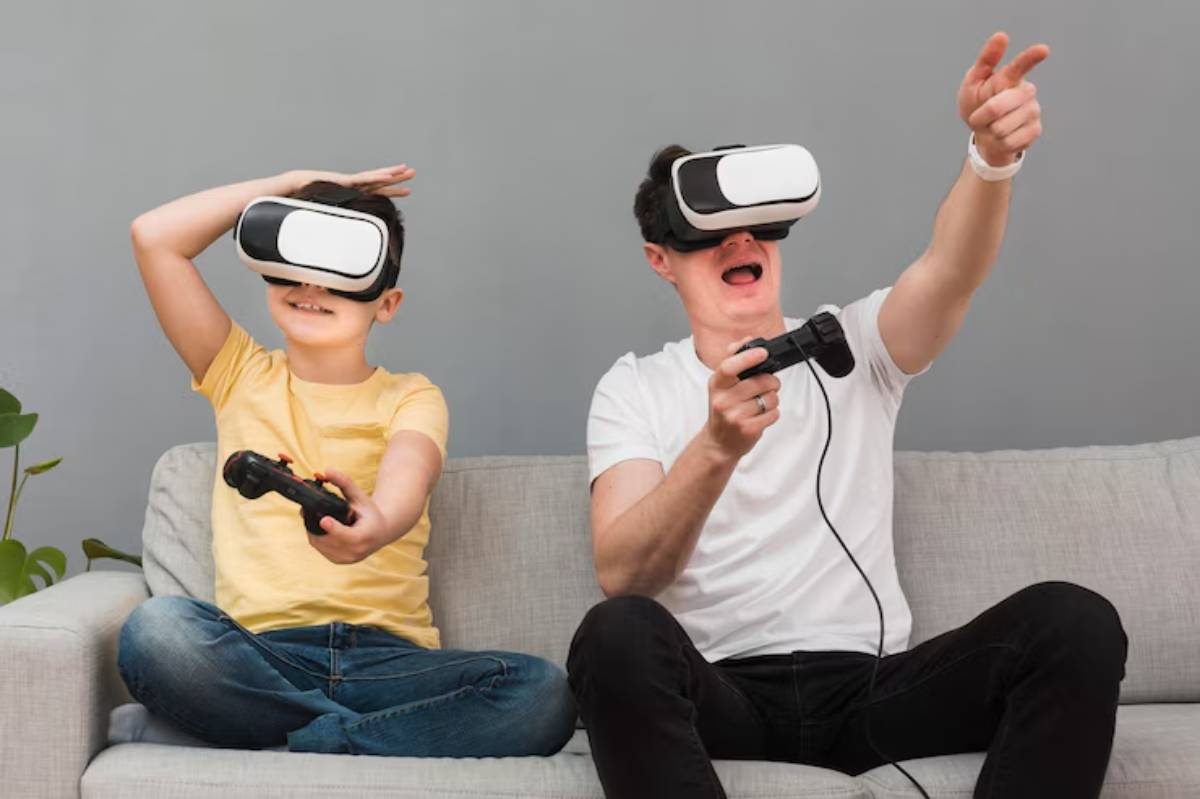 A child and an adult are sitting on a gray sofa, both wearing virtual reality headsets and engaged in an interactive gaming experience.