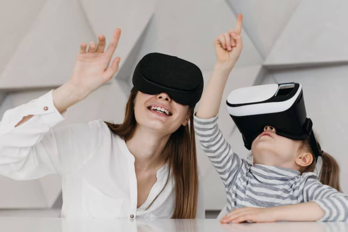 A child wearing a virtual reality headset excitedly raises a hand, while an adult shares a moment of engagement beside them.
