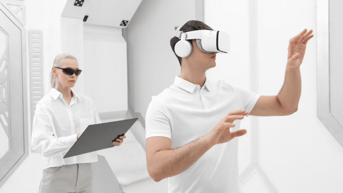 A person wearing a VR headset interacts with a virtual environment while another individual observes and holds a clipboard.