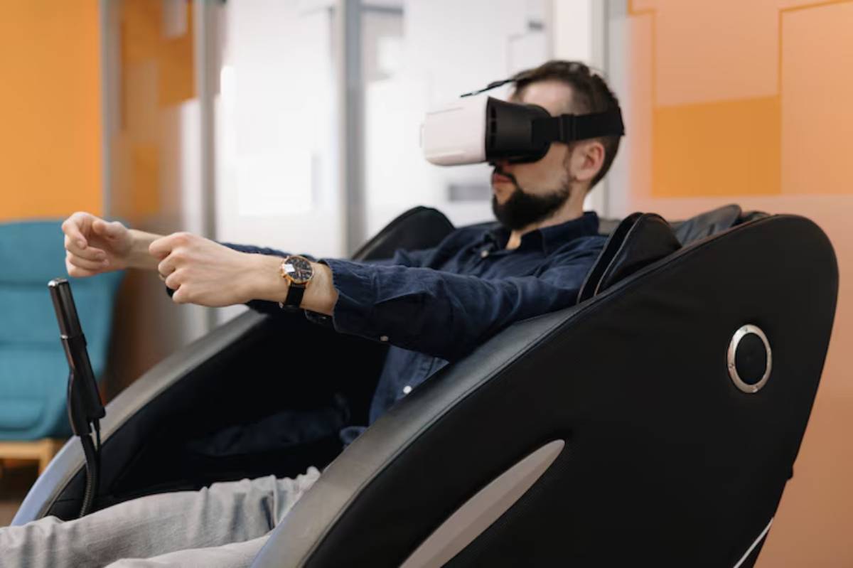 A person wearing a virtual reality headset sits in a modern gaming chair, hands gripping a control device, focused on an immersive experience.