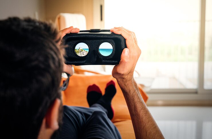 man looking at a VR simulator while relaxing at home