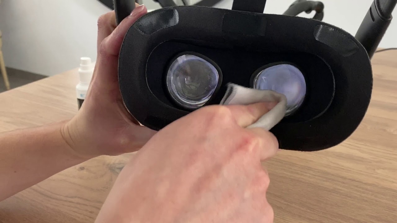 person cleaning VR lenses with cloth